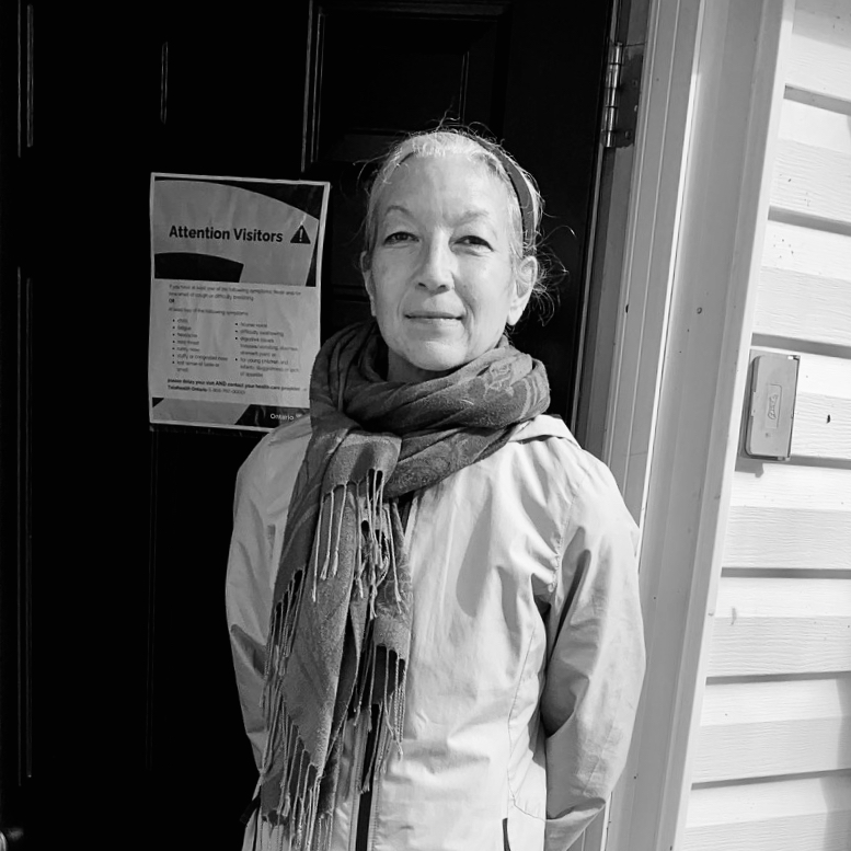 black and white woman looking happy in front of door